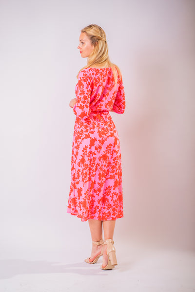 Ružovo červené kvetinové midi šaty odfotené zozadu